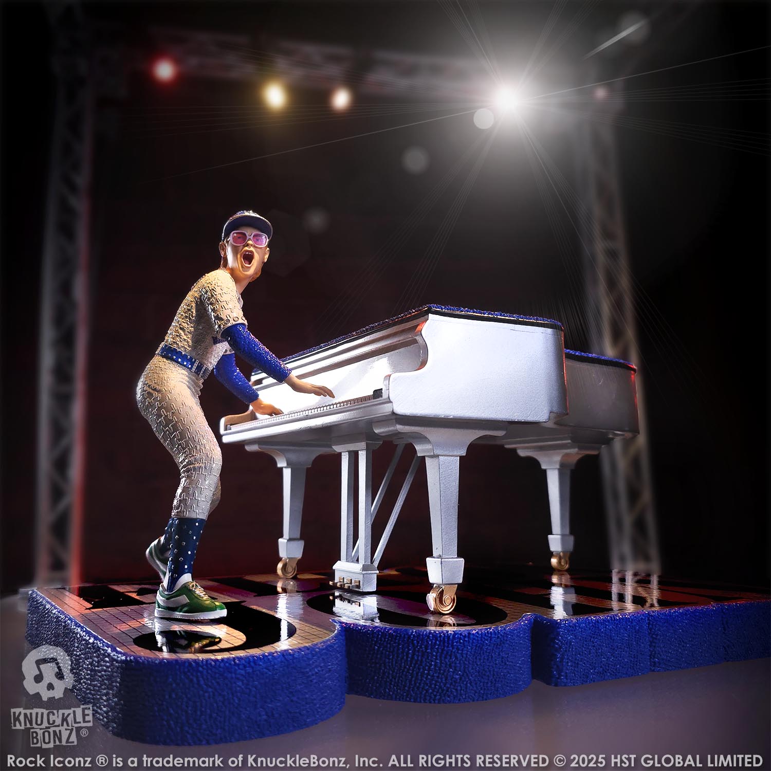 Statue of Elton John with a grand piano in a baseball uniform with a lighted background